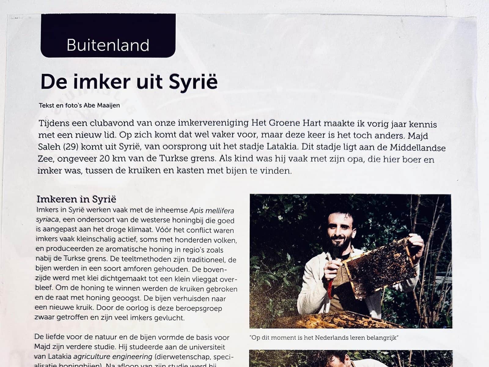 The article ‘De imker uit Syrië’ in Bijenhouden, the NBV magazine, with a photo of Majd Saleh holding a frame of bees